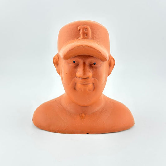 Terracotta-colored bust of a man wearing a cap on a light gray background