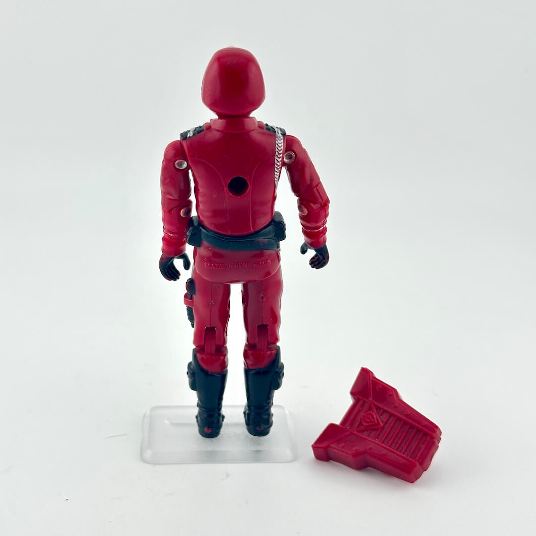 Red action figure with a red accessory on a white background