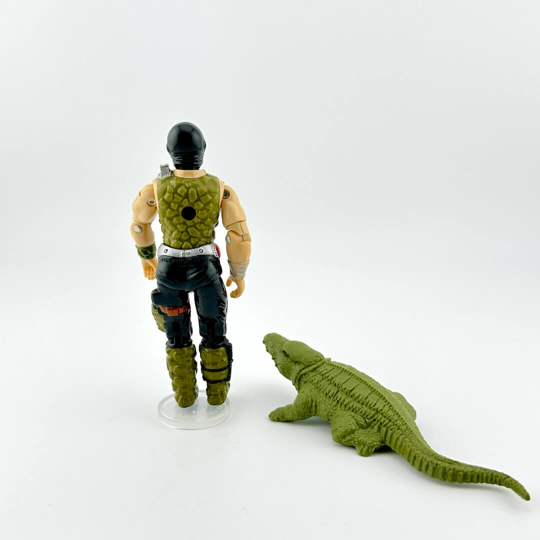 Action figure with a green creature on a white background