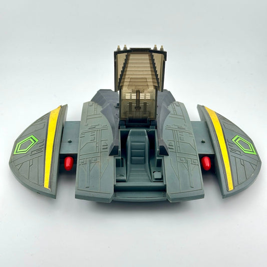 Toy spaceship model on a light gray background