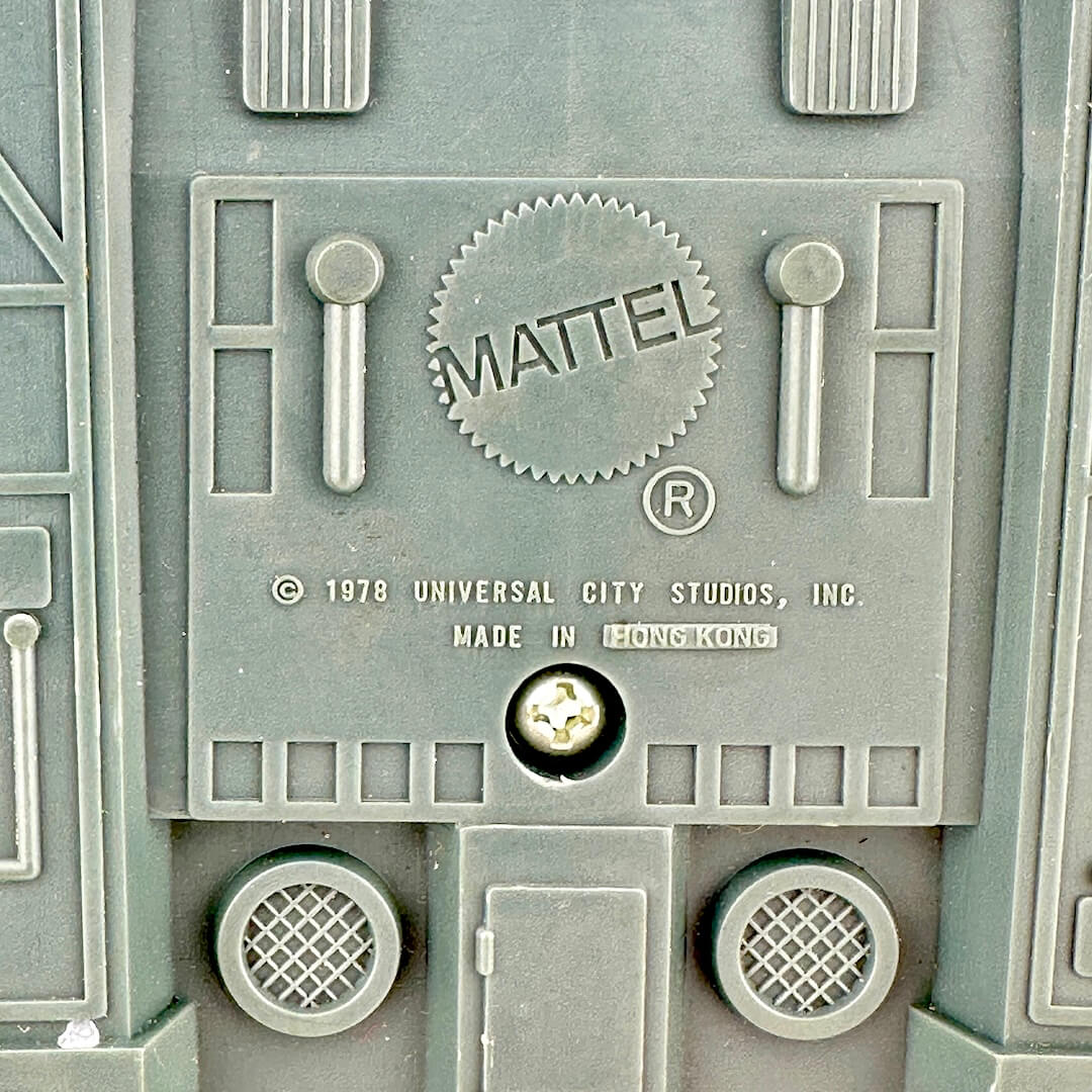 Close-up of a Mattel logo on a toy structure with branding details.