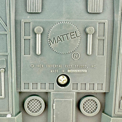 Close-up of a Mattel logo on a toy structure with branding details.
