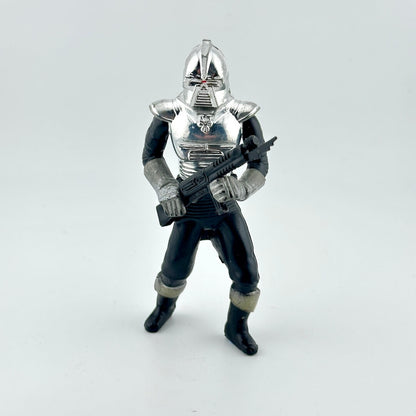 Toy figure of a character in silver armor holding a weapon on a white background
