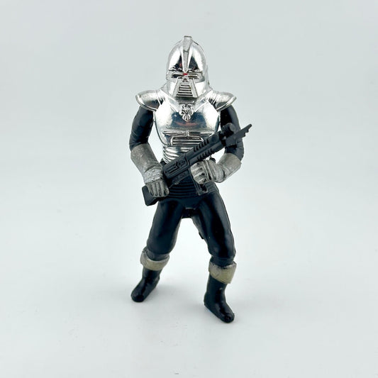 Toy figure of a character in silver armor holding a weapon on a white background