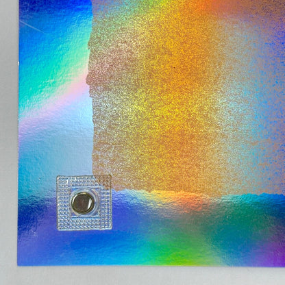 Bottom left corner with light scratch to holo paper. 