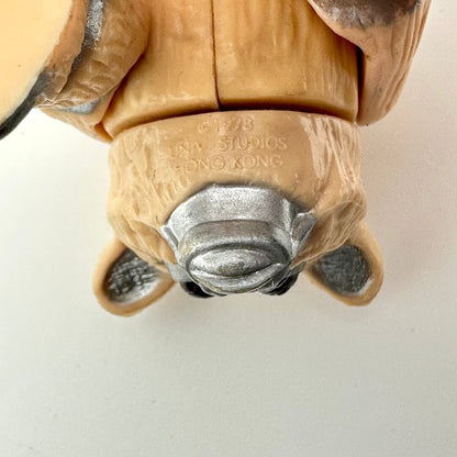 Close-up of a toy figure's head with  branding on a white background