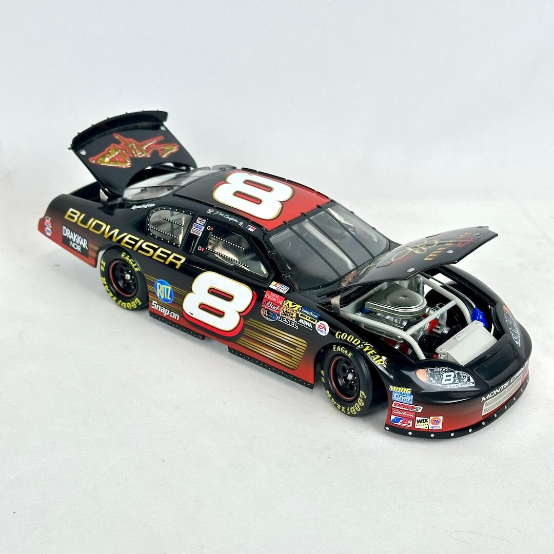 Model race car with open hood on a white background