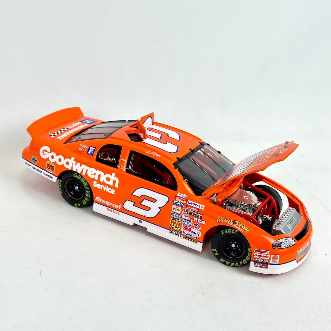 Model race car with open hood on a white background
