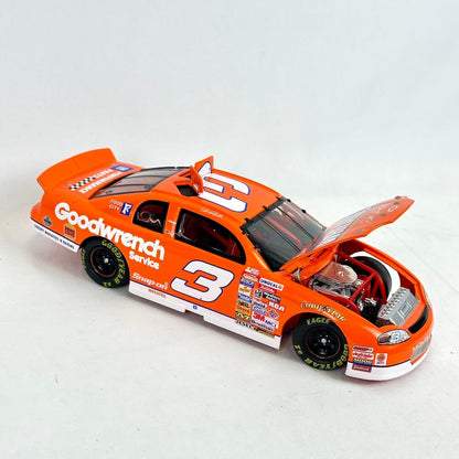Model race car with open hood on a white background