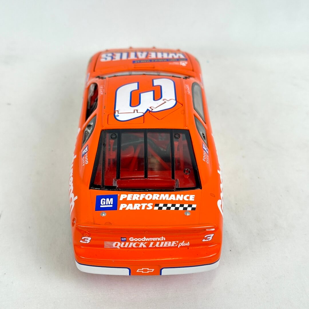Model car with various sponsor logos on a white background