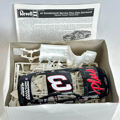 Model car kit with unassembled parts and a box featuring Dale Earnhardt branding.