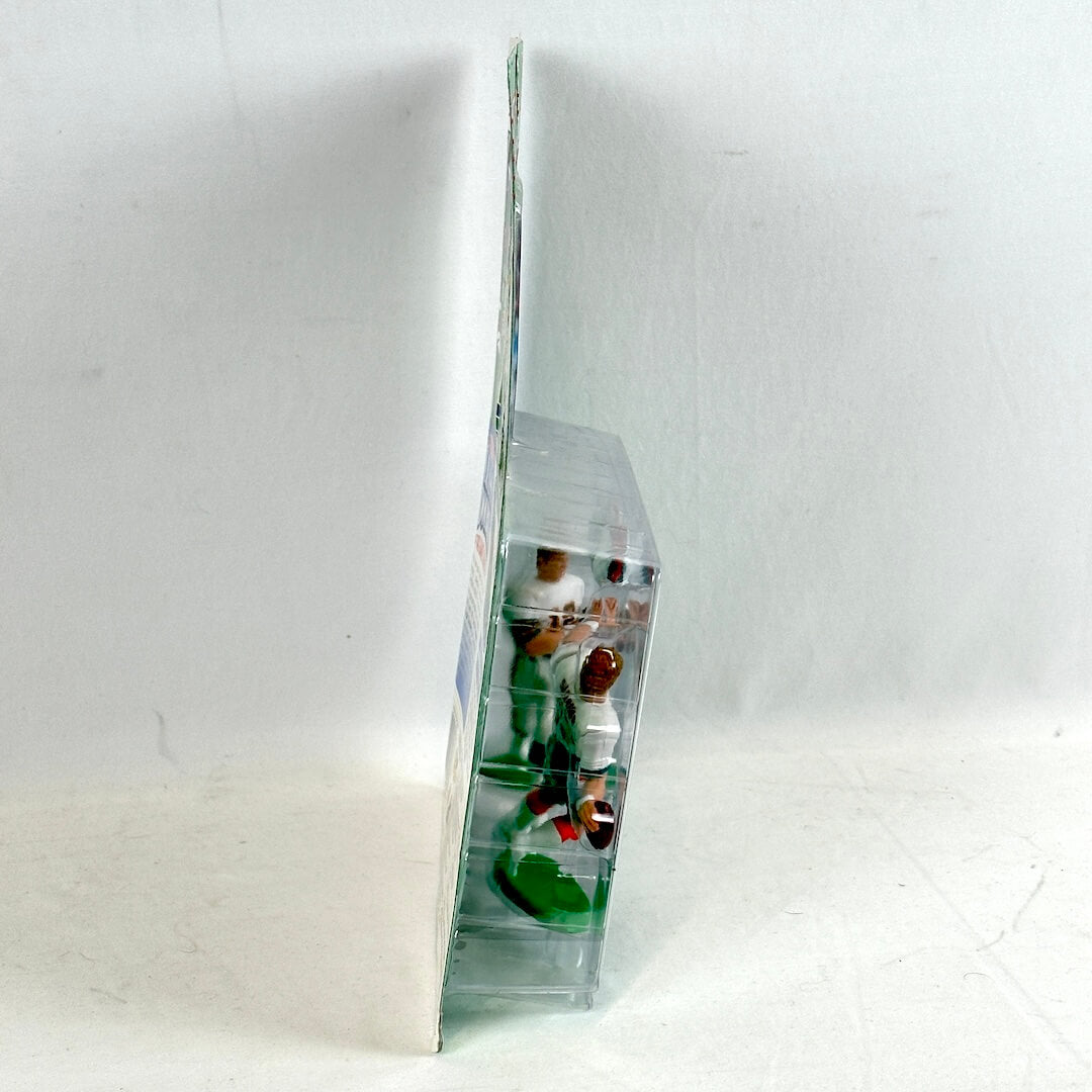 Two small figurines in a clear plastic display case on a white background
