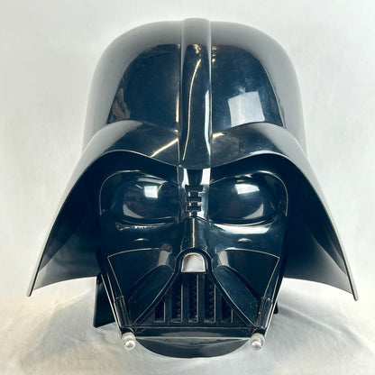 A glossy black Darth Vader helmet replica photographed from the front against a plain light background.