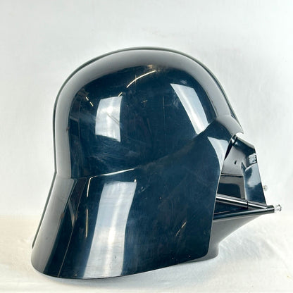 Side view of glossy black Darth Vader helmet on white background. Pictured without stand.