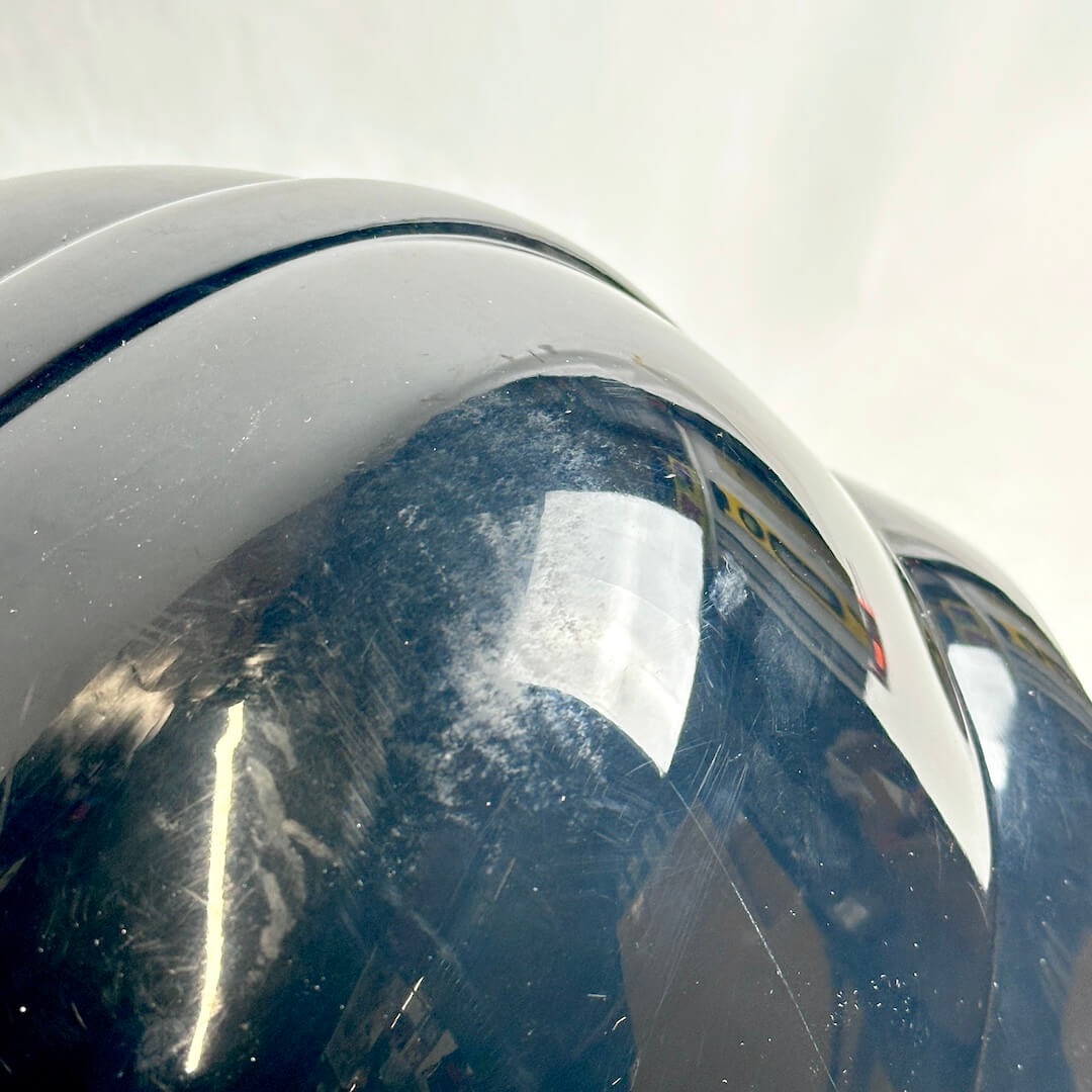 Close-up of top of helmet to show signs of wear in scuffs and scratches. 