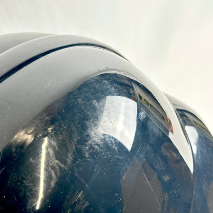 Close-up of top of helmet to show signs of wear in scuffs and scratches. 