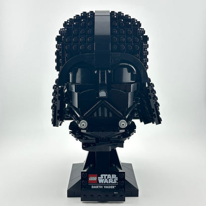 Darth Vader Lego helmet with stand against white background. 