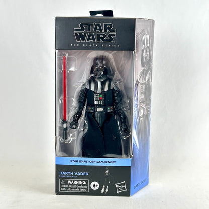 Star Wars The Black Series Darth Vader action figure in its original window box packaging, featuring a figure with a red lightsaber.