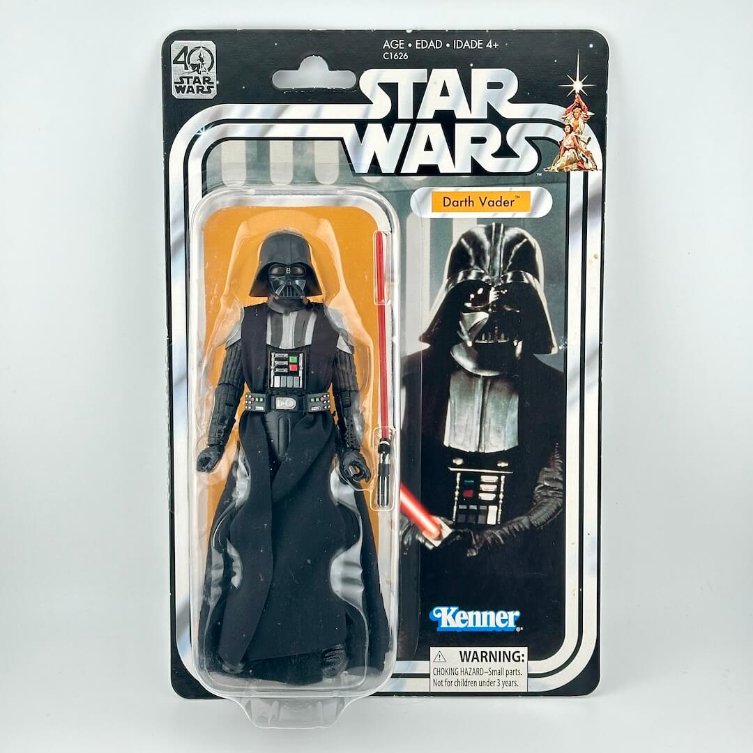Star Wars action figure in its original blister packaging with retro-style card back; figure in all black with helmet. 
