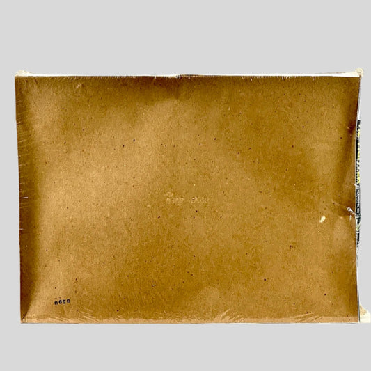 back of plastic wrapped box showing concave nature of box but no other damage visible. 