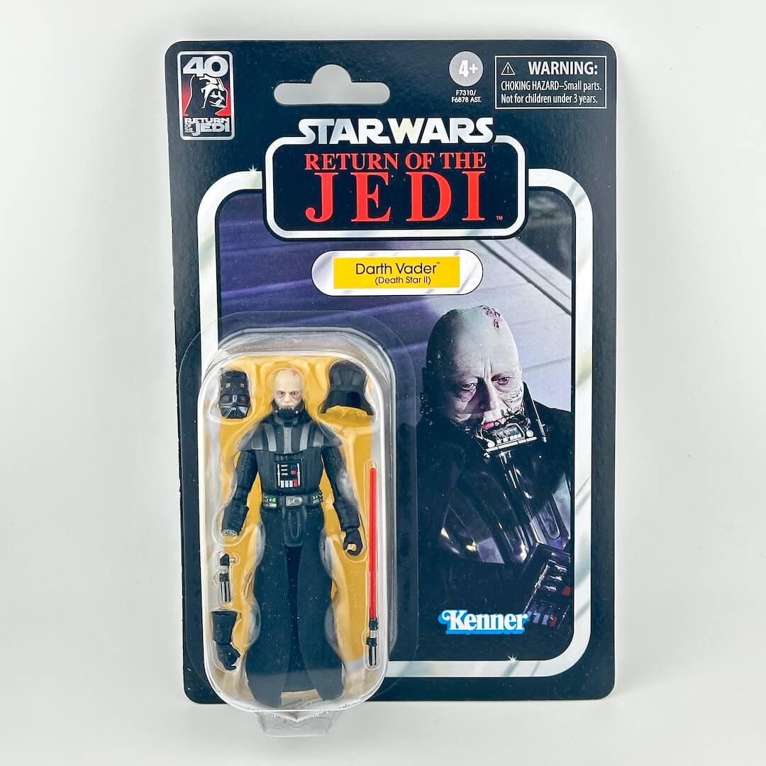Star Wars action figure of unmasked Darth Vader with original blister packaging featuring retro-style card back.