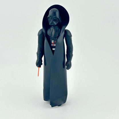 Toy figure of a character in dark costume with a red light saber on a white background