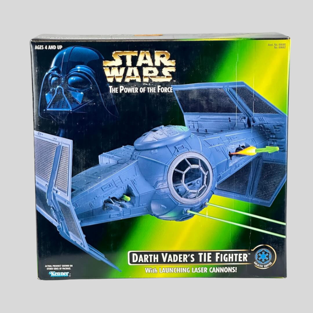 Box of Darth Vader's TIE Fighter toy from Star Wars on a gray background