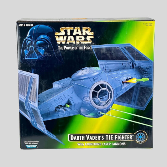 Box of Darth Vader's TIE Fighter toy from Star Wars on a gray background
