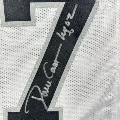 Close-up of a sports jersey with a silver signature on number patch on a white jersey background