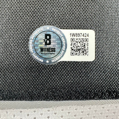 Authenticity label with QR code and text on a textured surface