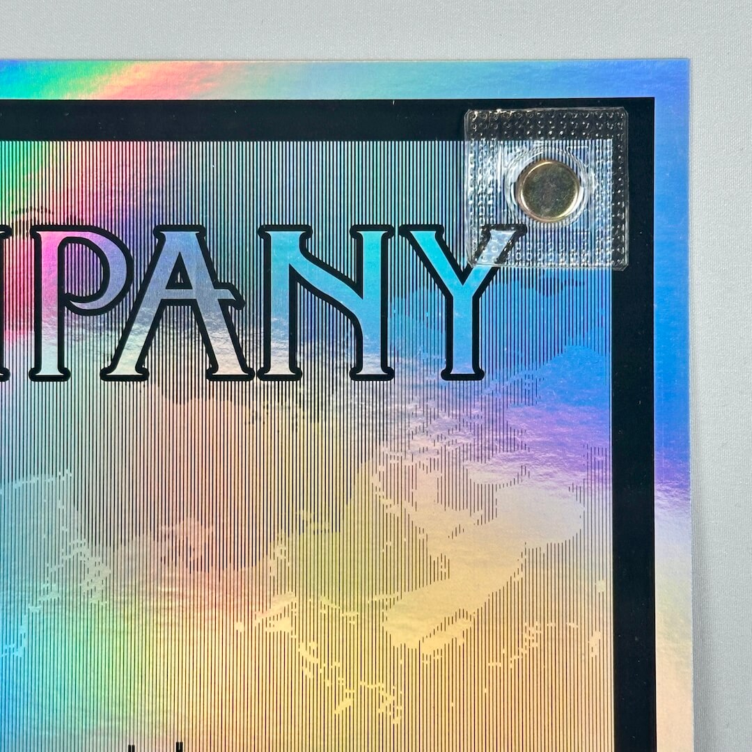 Top right corner of poster showing no damage to corner or edges, rainbow foil aspect of poster visible. 