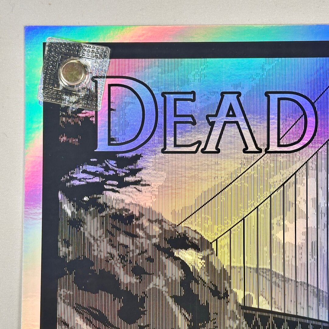 Colorful background poster with 'DEAD' text and a silhouette of the golden gate bridge. Top left corner undamaged.