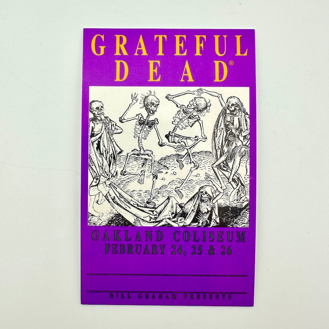 A purple Grateful Dead concert laminate yellow 'GRATEFUL DEAD' at the top, a black-and-white illustration of dancing skeletons in the center. 