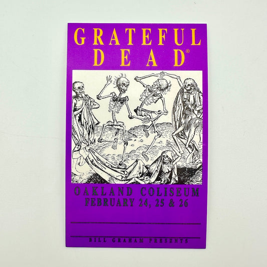 A purple Grateful Dead concert laminate yellow 'GRATEFUL DEAD' at the top, a black-and-white illustration of dancing skeletons in the center. 