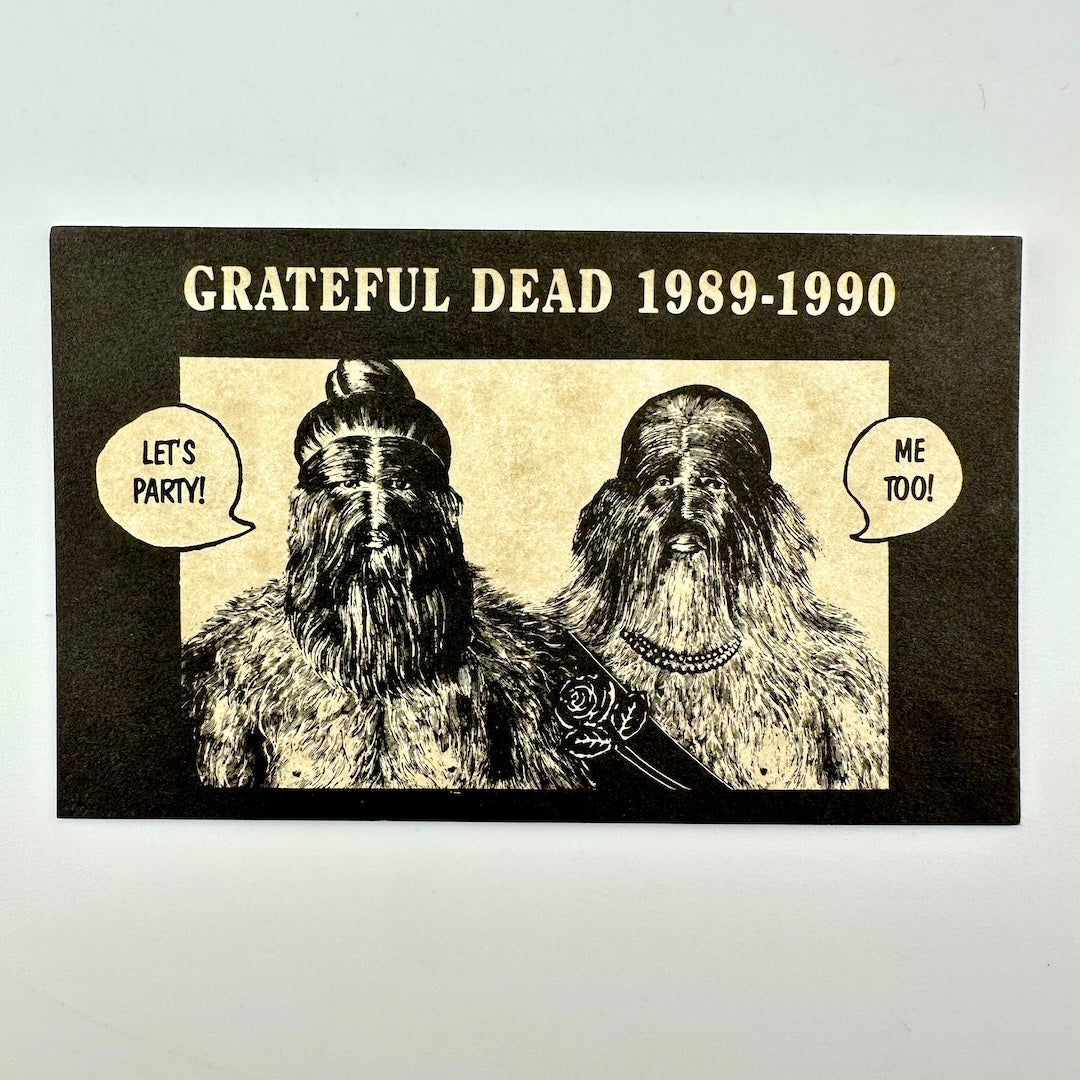 A rectangular printed card with 'GRATEFUL DEAD 1989-1990' above an illustrated portrait of two furry humanoid figures with speech bubbles. 