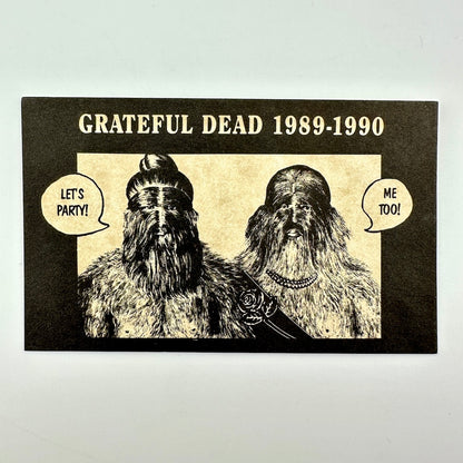 A rectangular printed card with 'GRATEFUL DEAD 1989-1990' above an illustrated portrait of two furry humanoid figures with speech bubbles. 