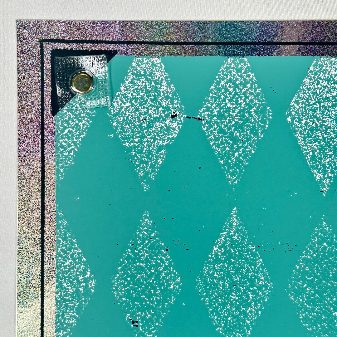Top left corner showing tiny pin hole at corner of border that's nearly undetectable. 