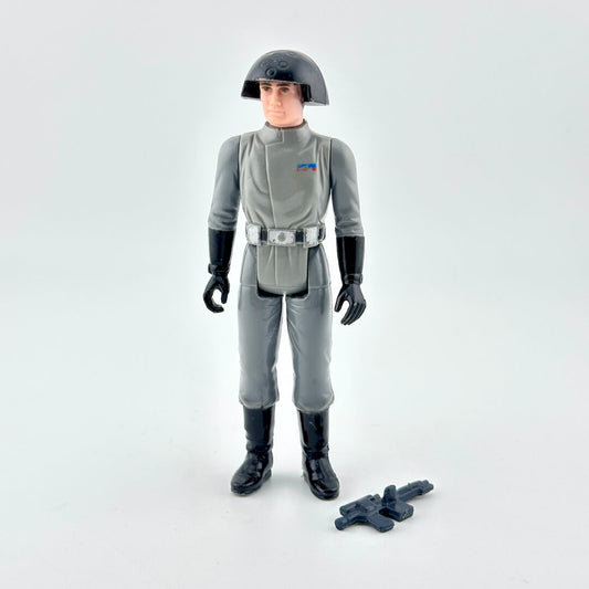 Action figure in gray military uniform with helmet and weapon on white background. 