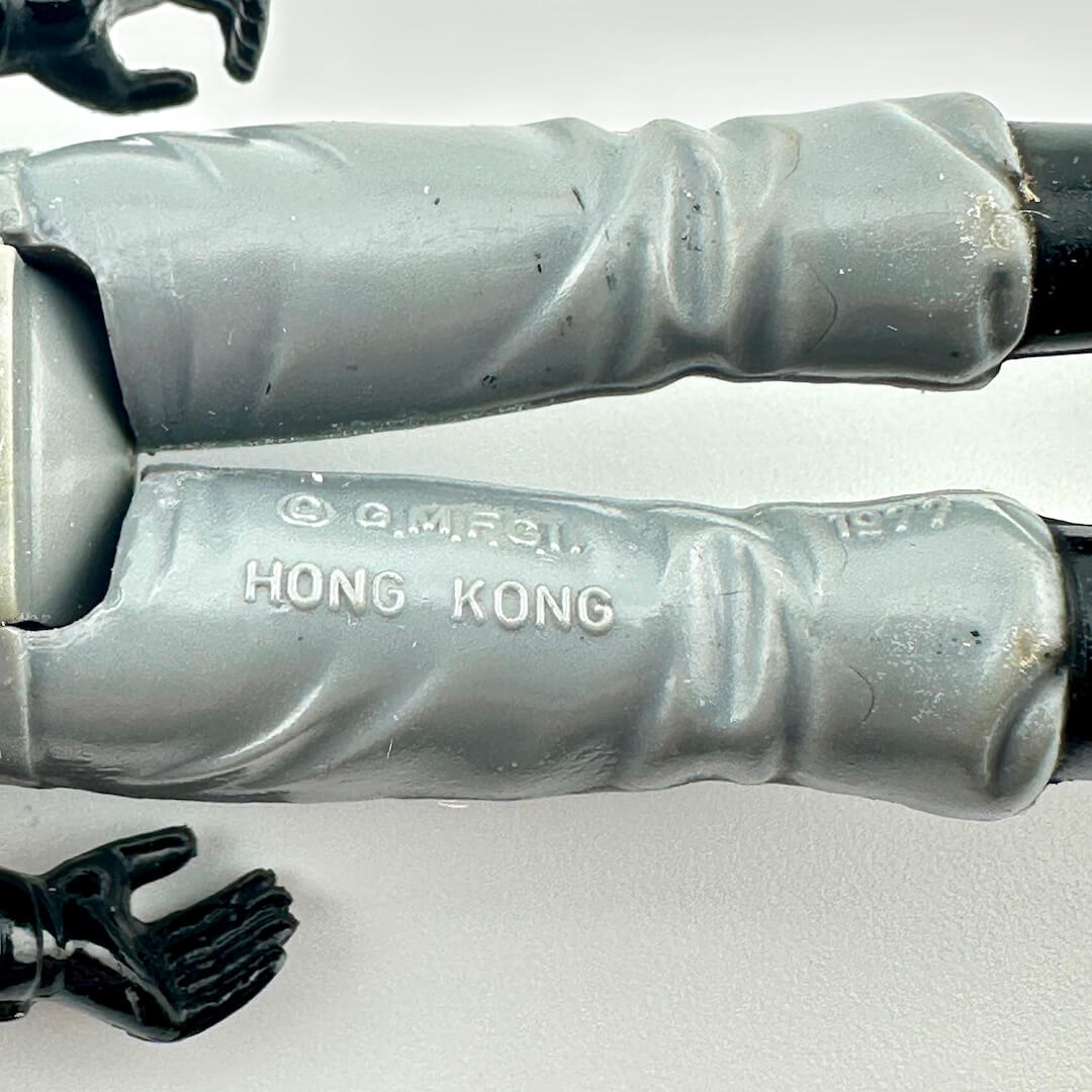 Close-up of back of figure's legs to show copyright and COO information. 