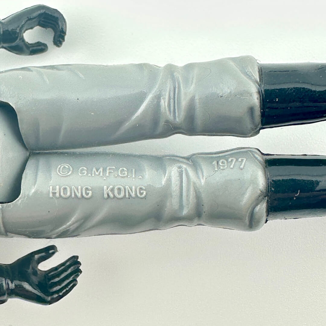 Back of figure's legs to show COO and copyright information.