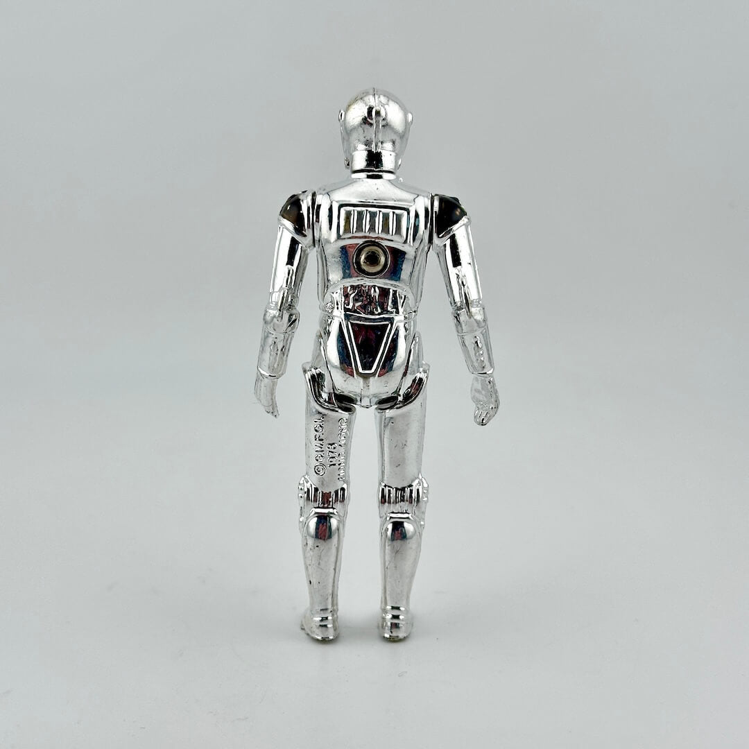 Silver robot toy figure on a gray background