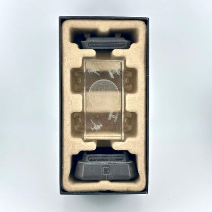 Interior contents of retail box for Death Star Light, showing base, top, and etched crystal middle pieces. 