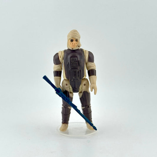 Action figure in a desert suit with a blue weapon on a white background