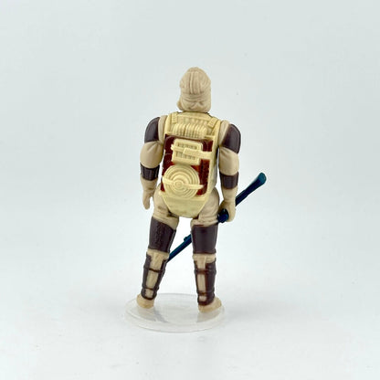 Action figure with a beige and brown outfit, holding a blue weapon on a white background