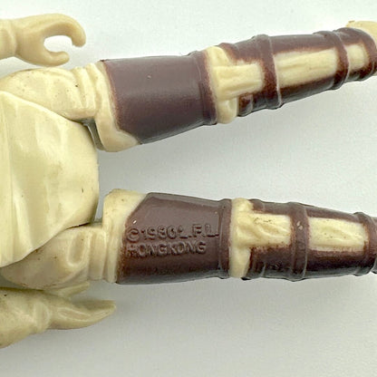 Close-up of a toy figure's legs with visible branding on a white background