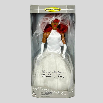 Doll in a wedding dress with veil and bouquet in packaging on a white background