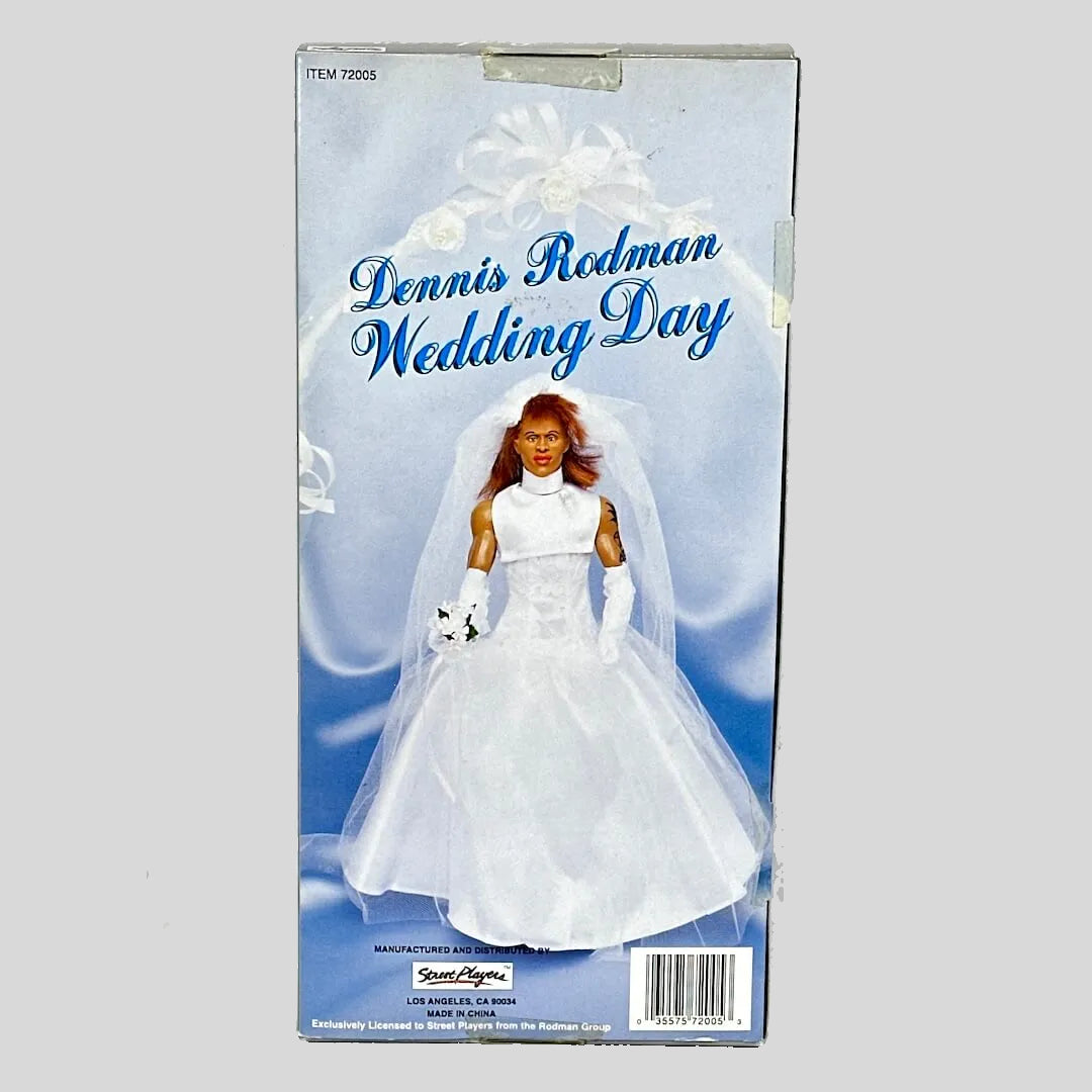 Boxed action figure of a person in a wedding dress with 'Dennis Rodman Wedding Day' text.