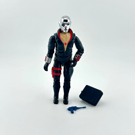 Action figure in a dark outfit with red accents on a white background
