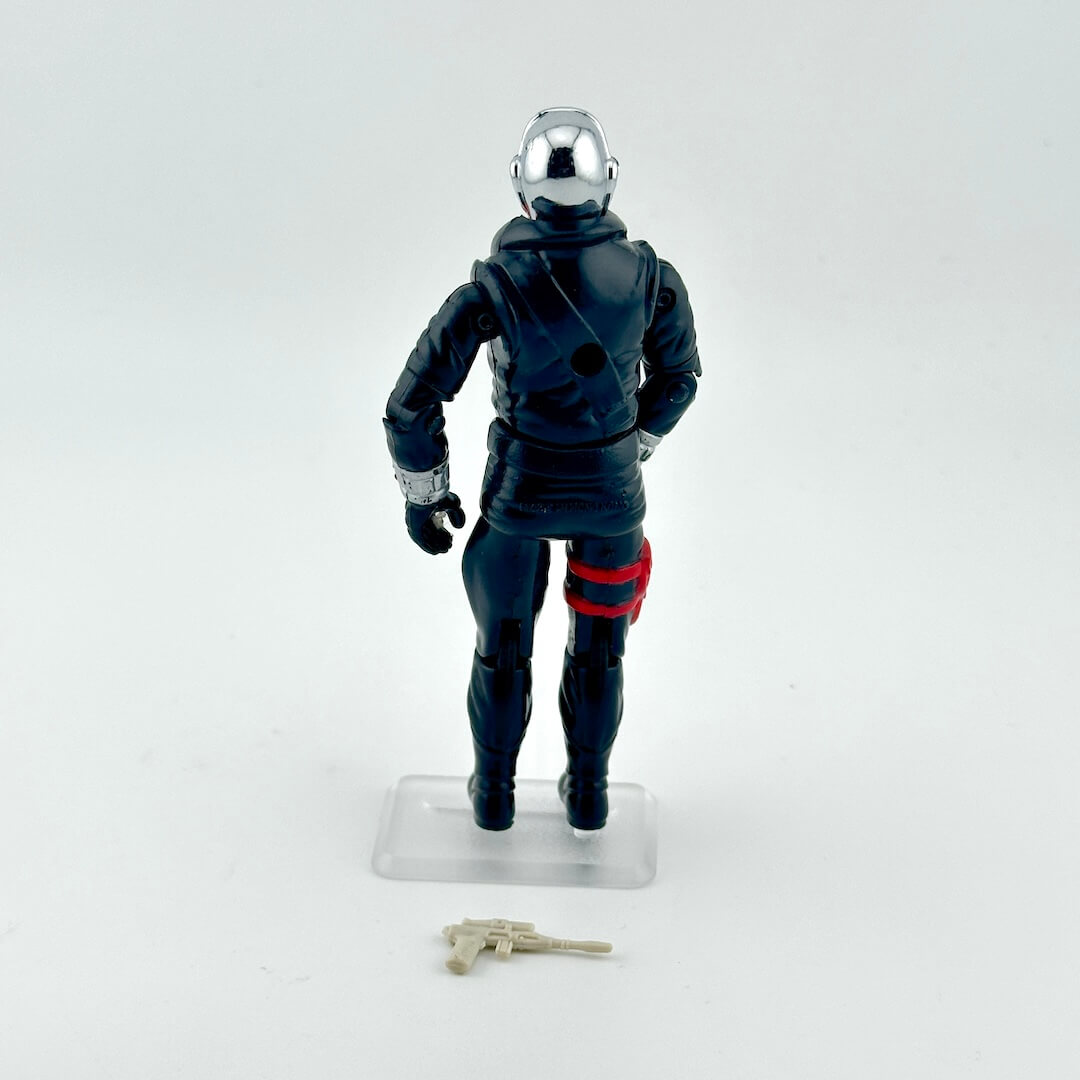 Action figure in a dark suit with a chrome head on a white background