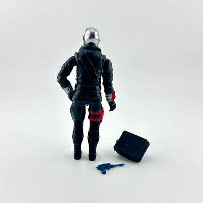 Action figure in black and red suit with a tool on a white background